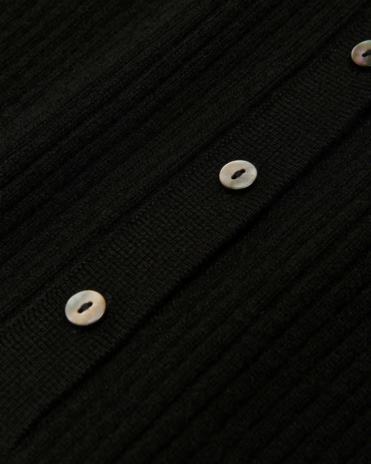 close-up of buttons on the black henley top