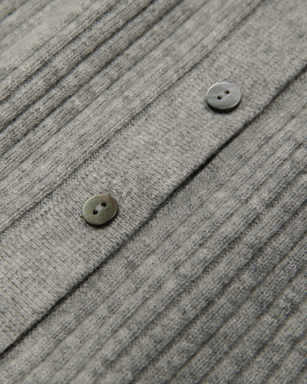 close-up of button and knit fabric detail
