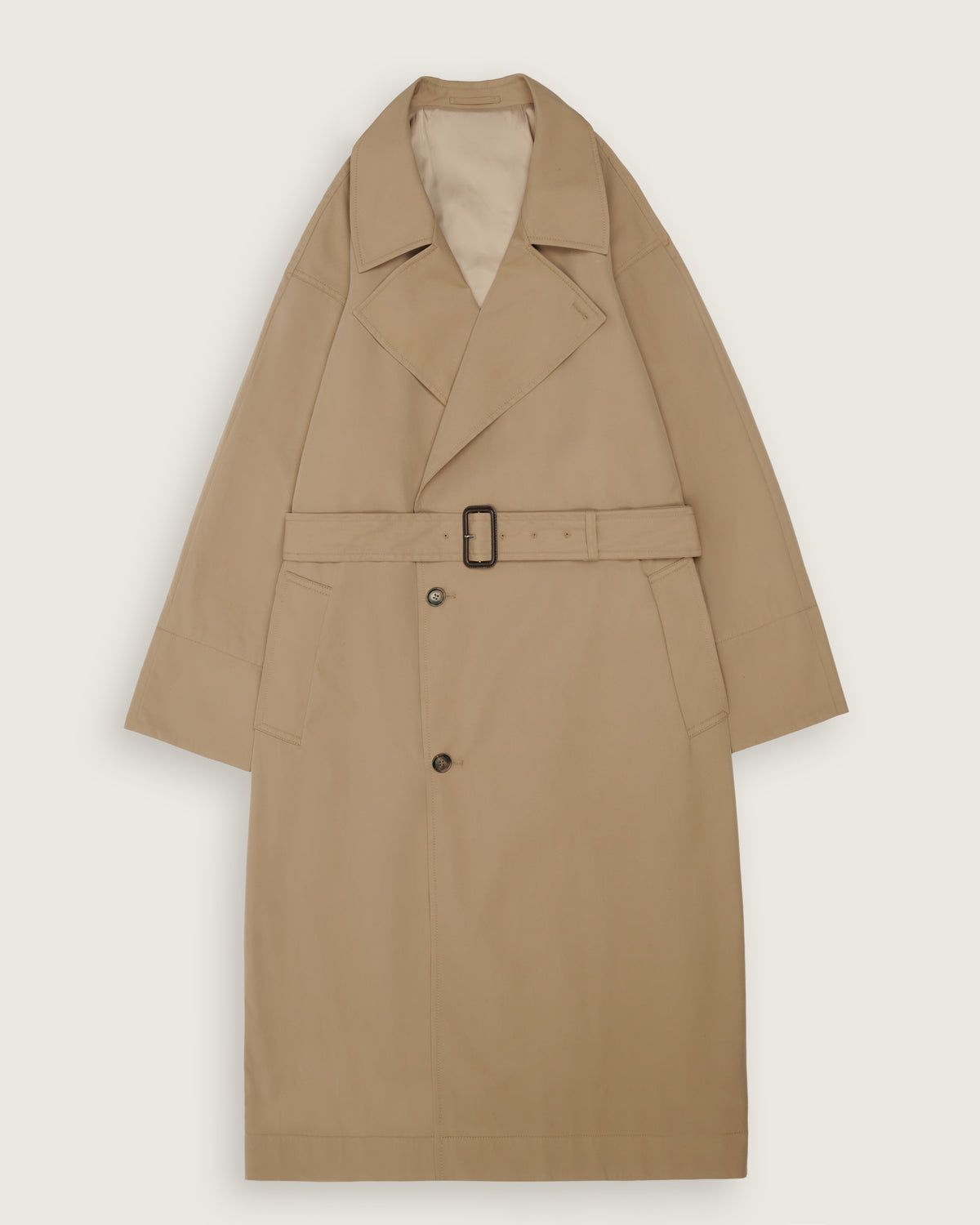 A classic beige trench coat with a matching waist belt and black buckle, displayed flat against a light beige background.