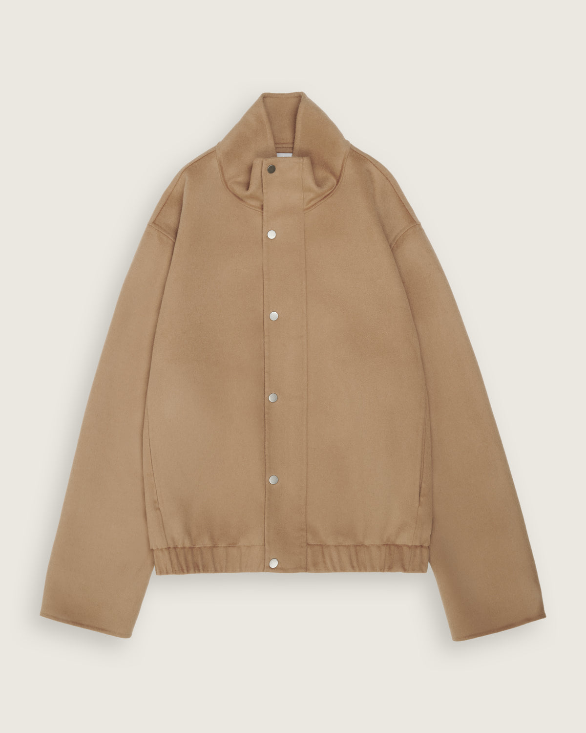 flat lay of the camel cropped double faced bomber