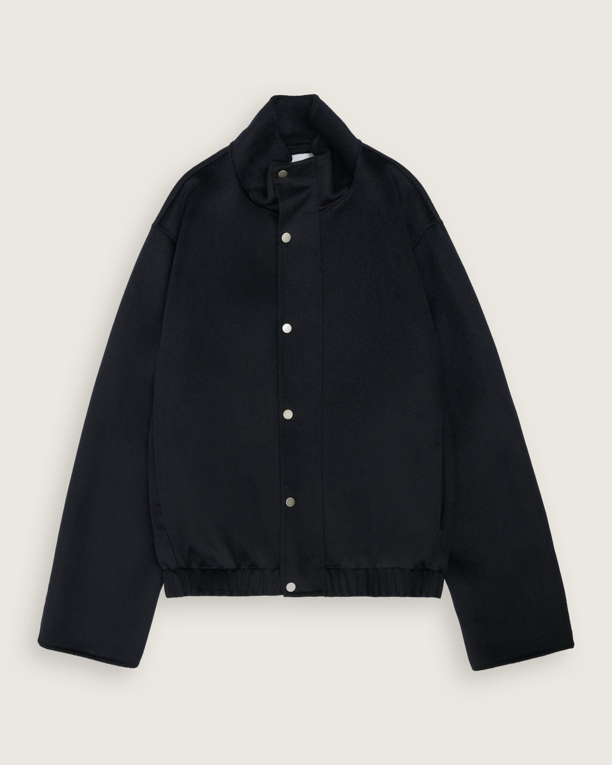 flat lay of the dark navy cropped bomber