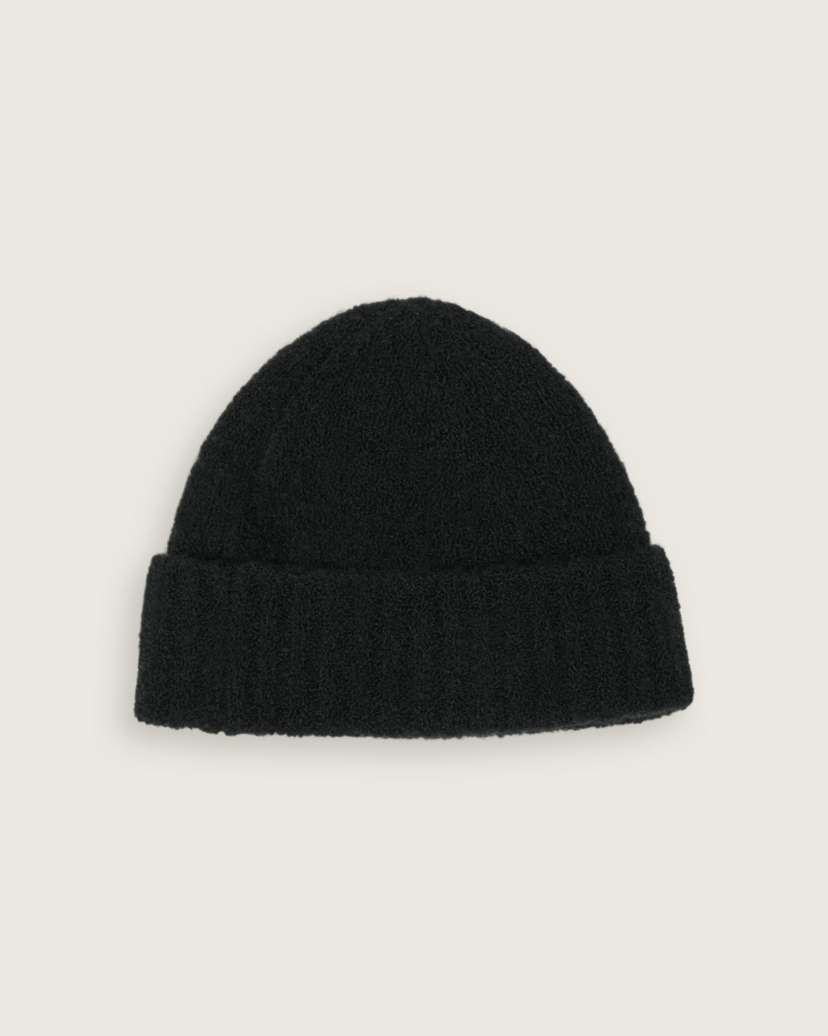 flat lay of the black boucle beanie