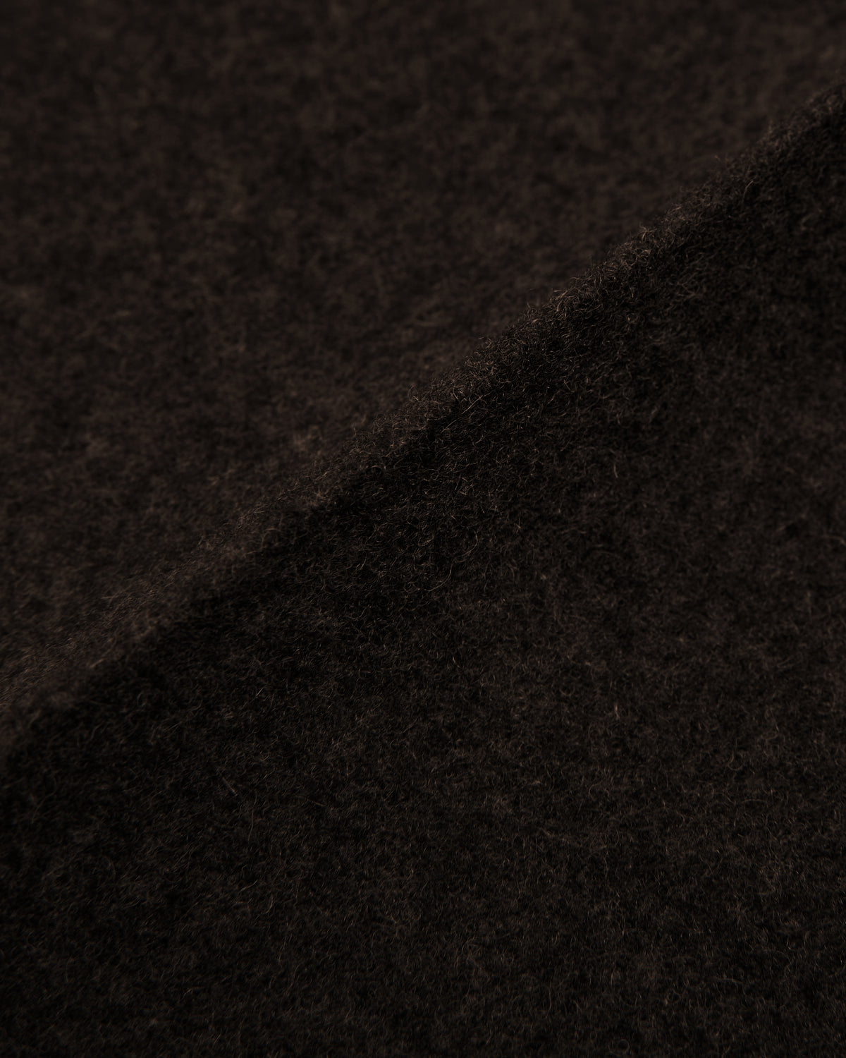 close-up of the chocolate brown pleated pants fabric