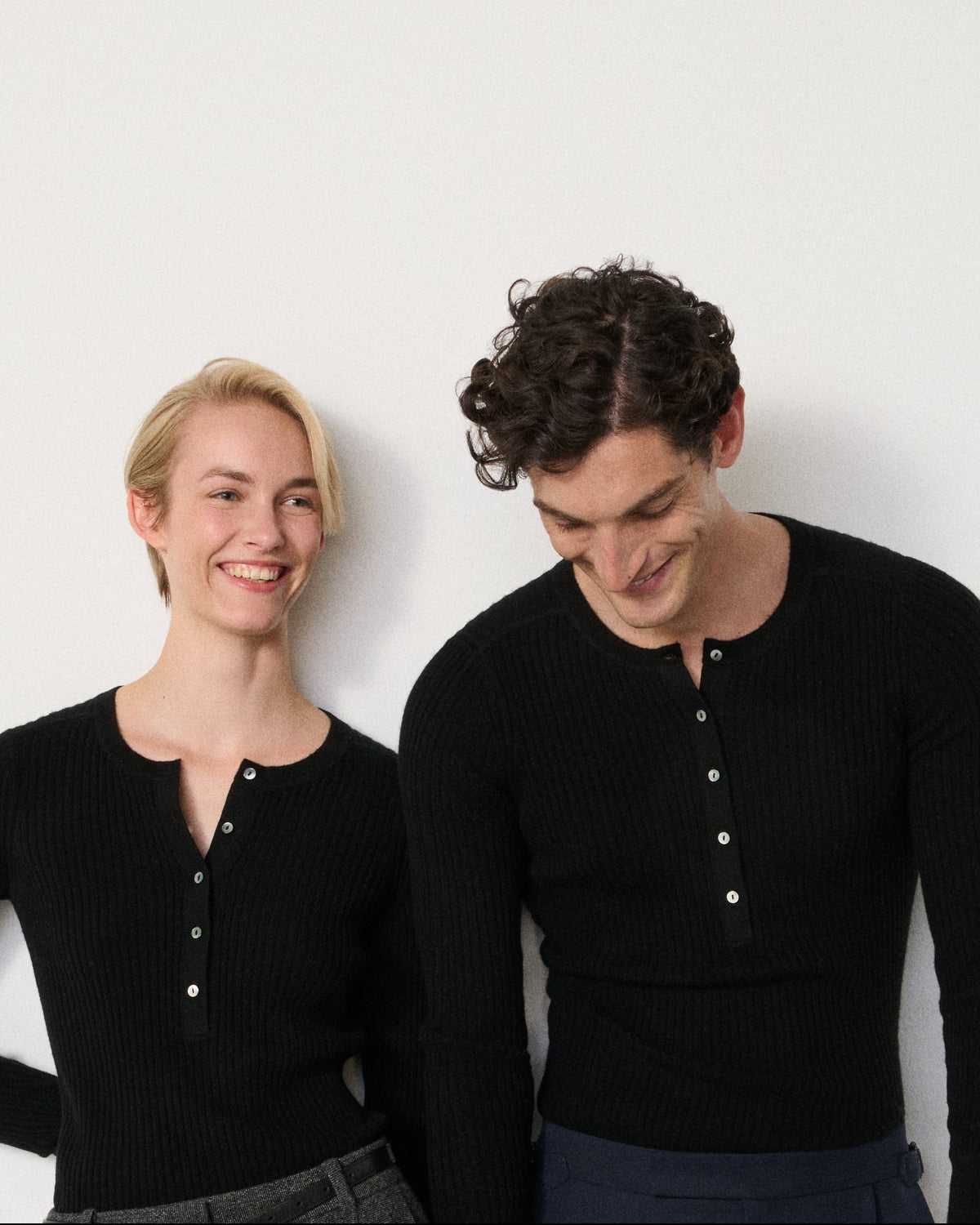 man and woman smiling in the black henley top