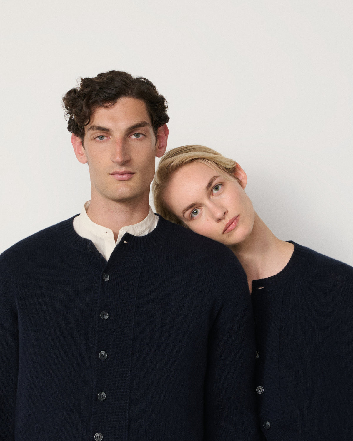 man and woman wearing the navy cropped cardigan