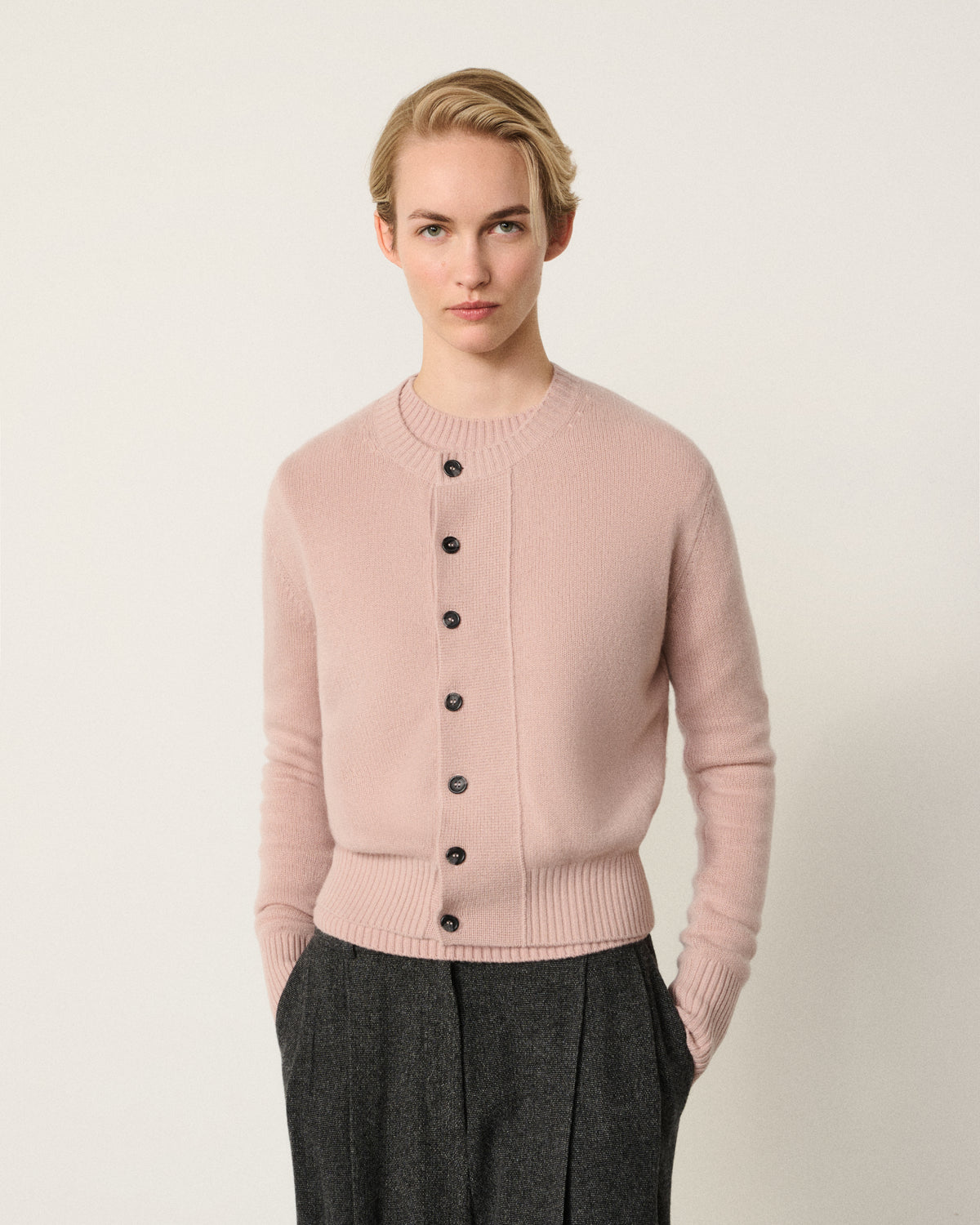 woman in the blush pink cropped cardigan, front view