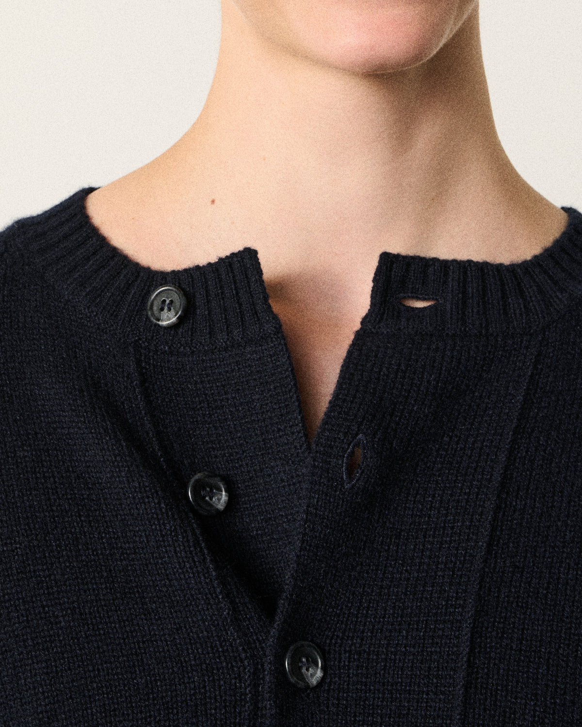 close-up of buttons on the navy cropped cardigan