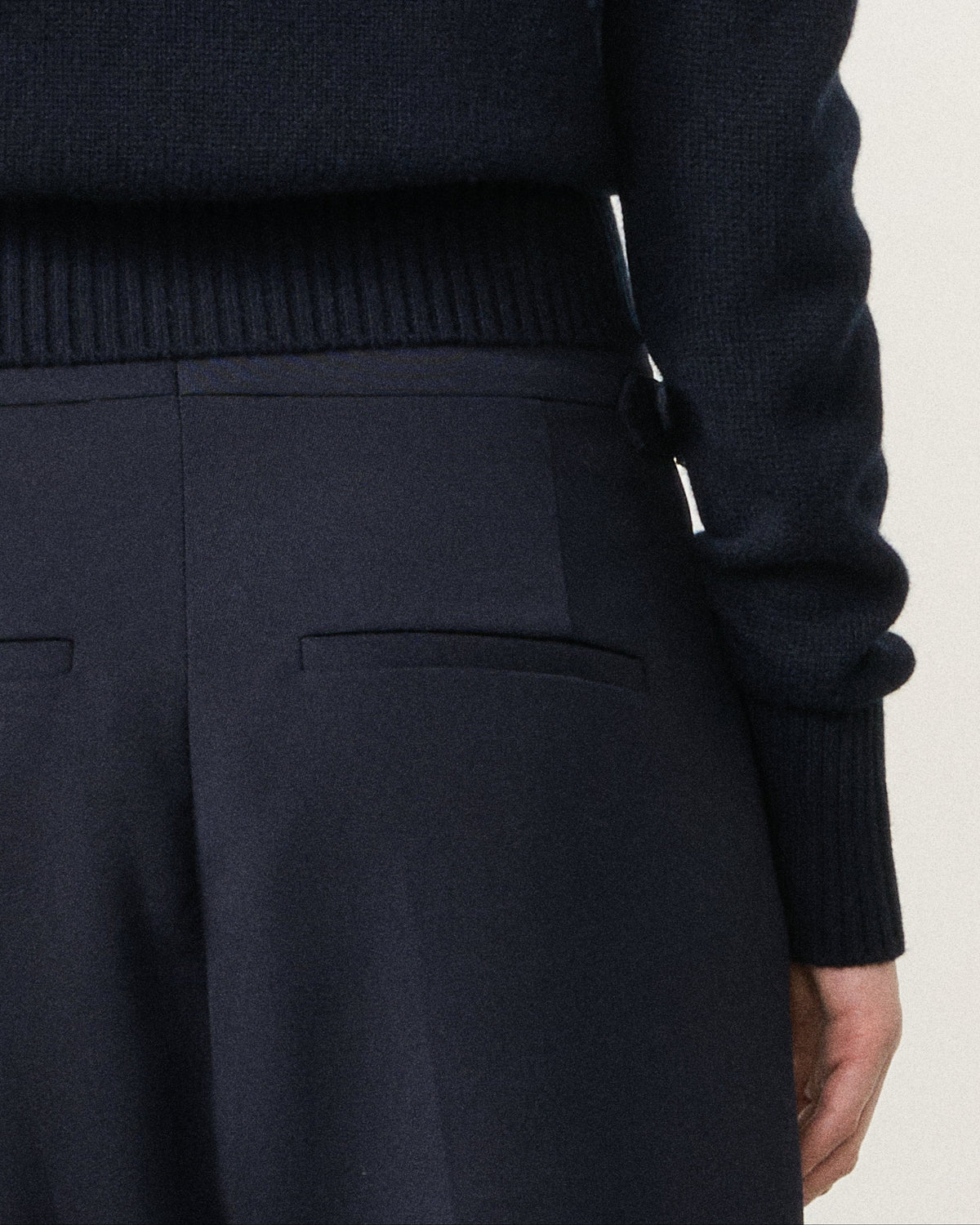 close-up of the navy cropped cardigan hem and trousers
