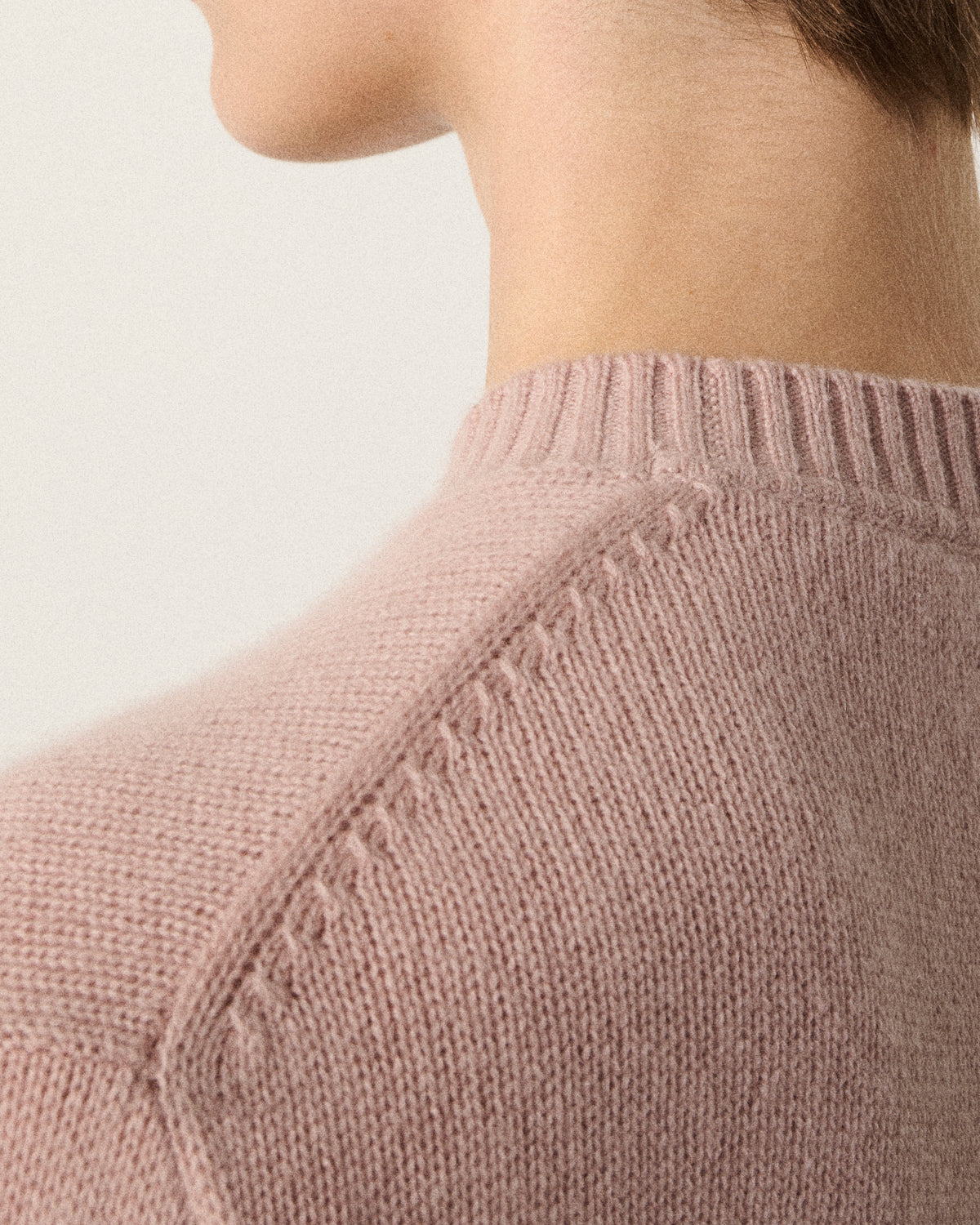 close-up of a woman's neck and shoulder in the blush pink sweater