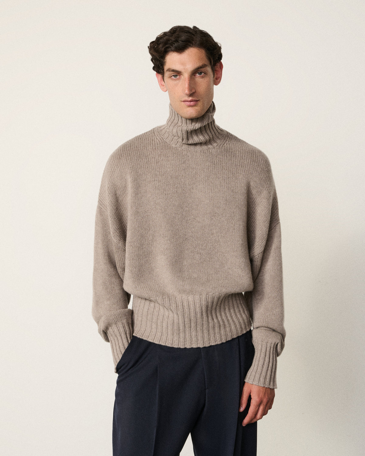 man wearing the mink relaxed turtle neck sweater