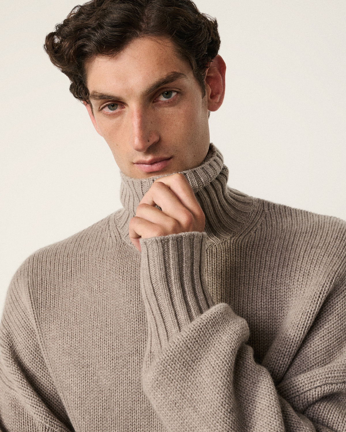 close-up of a man wearing the mink turtle neck sweater