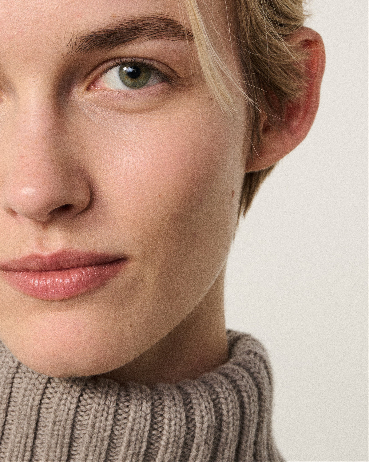 close-up of a woman wearing the mink turtle neck sweater