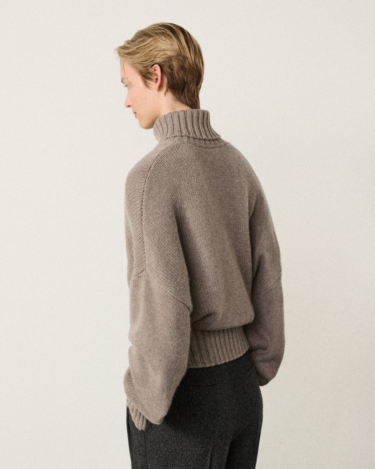 woman in the mink turtle neck sweater, back view