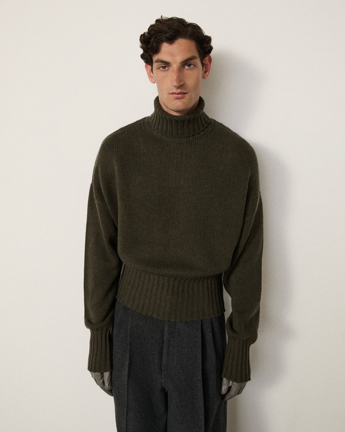 man in the olive relaxed turtle neck sweater, front view
