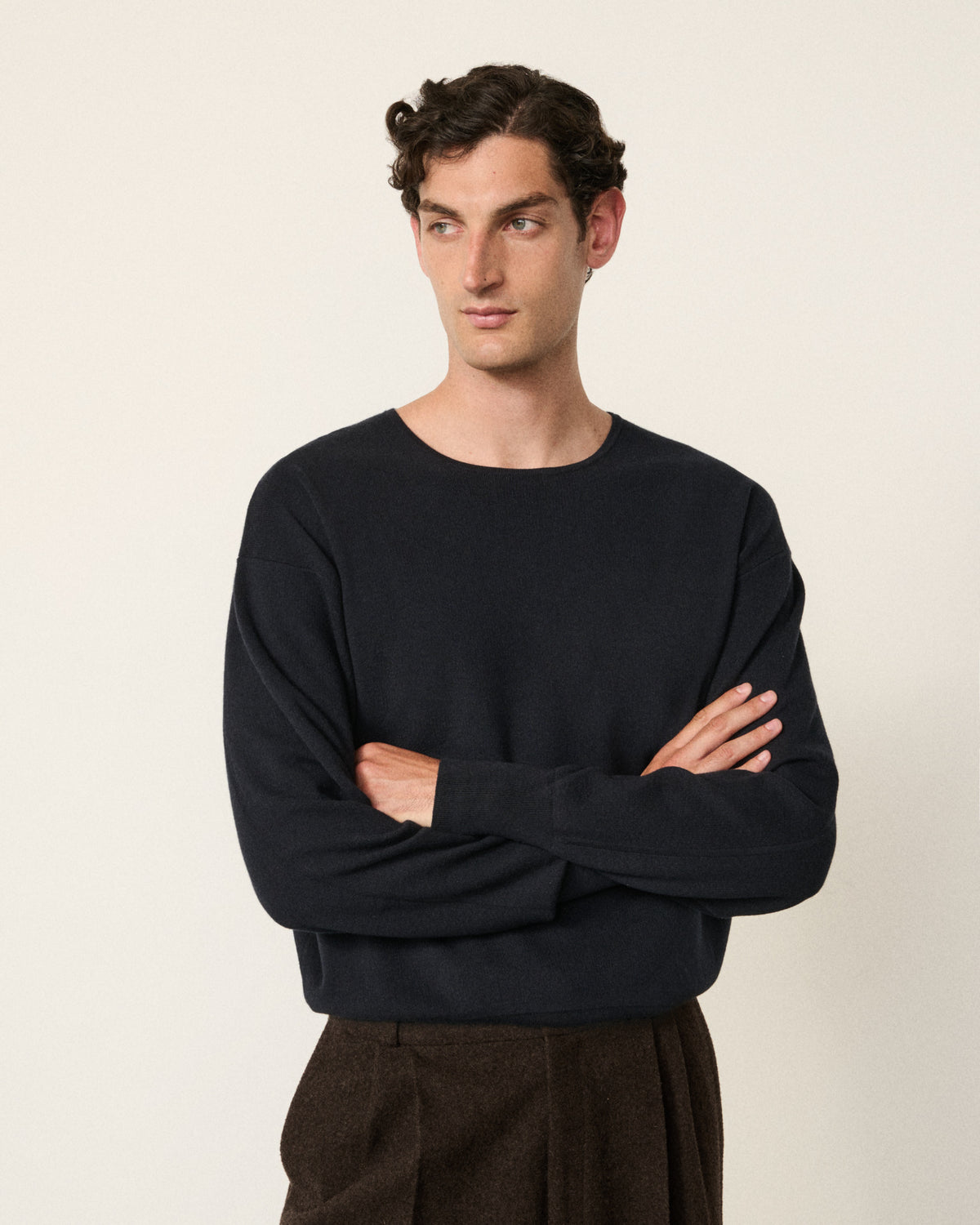 man wearing the indigo sweatshirt, arms crossed
