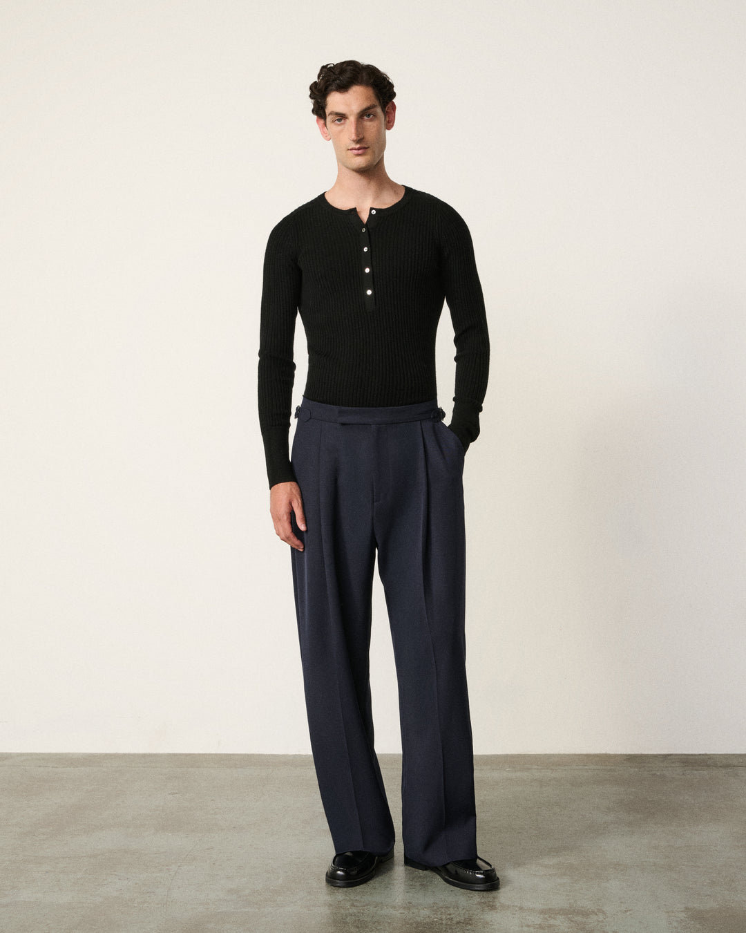 close-up of a man wearing the black henley top