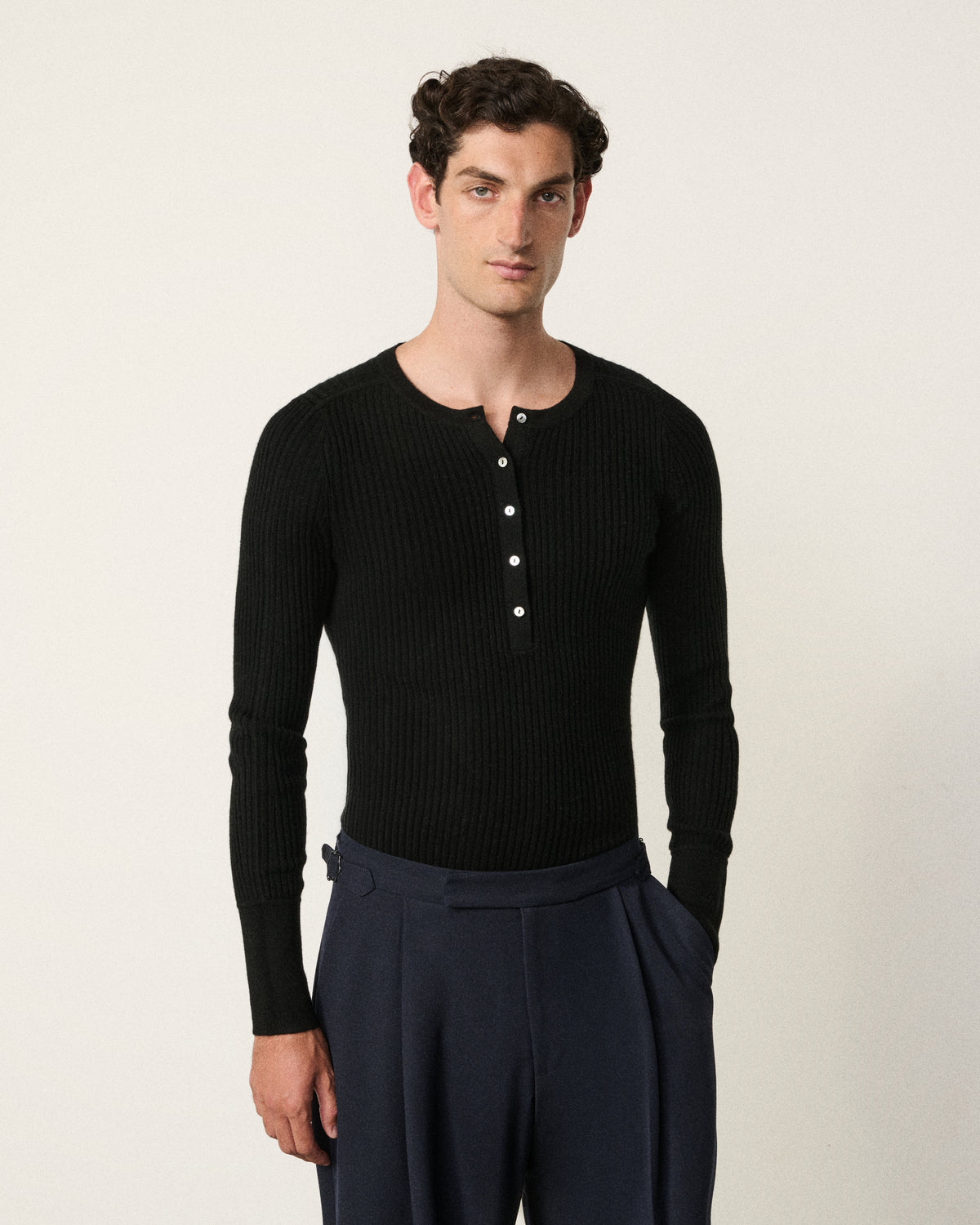 man wearing the black ribbed knitted henley top