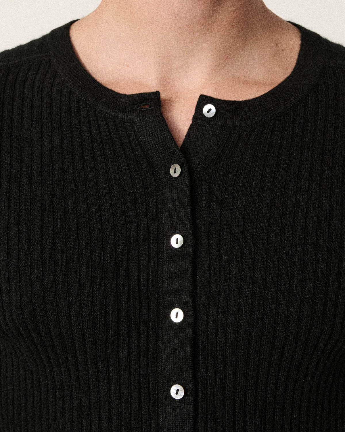 close-up of a man's neckline on the black henley top