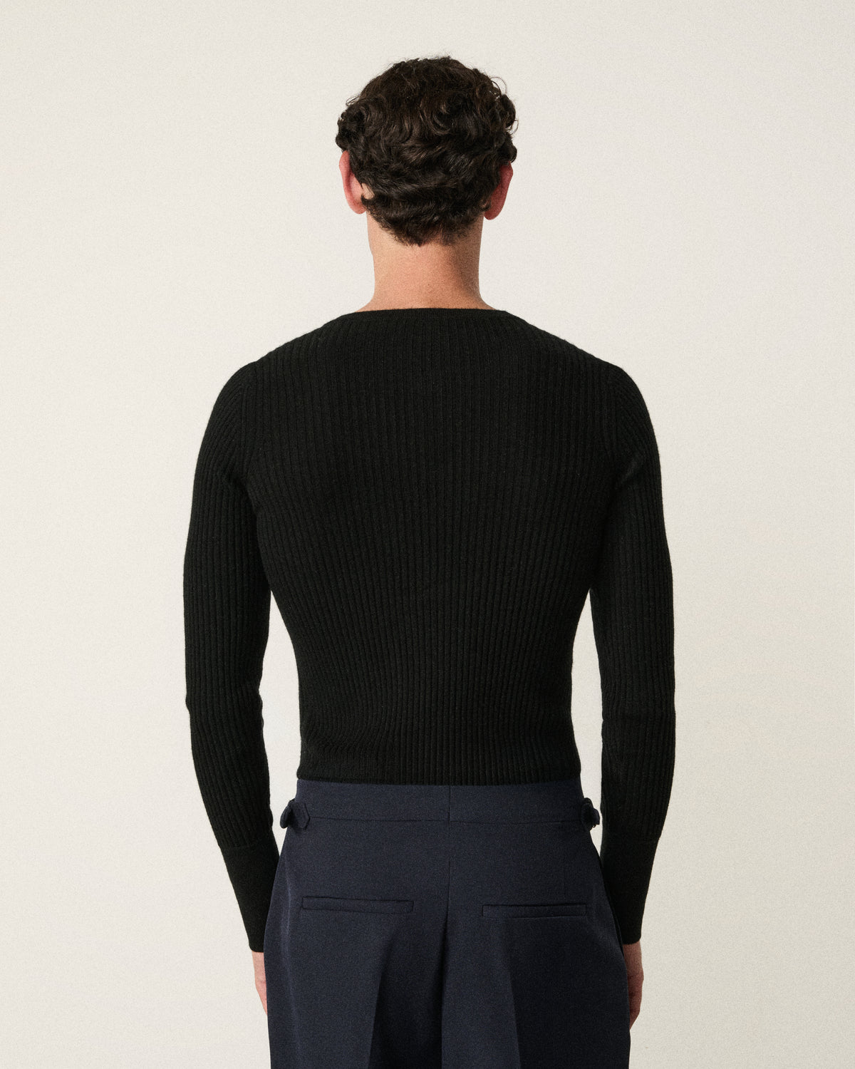 Man wearing henley top in black, back detail