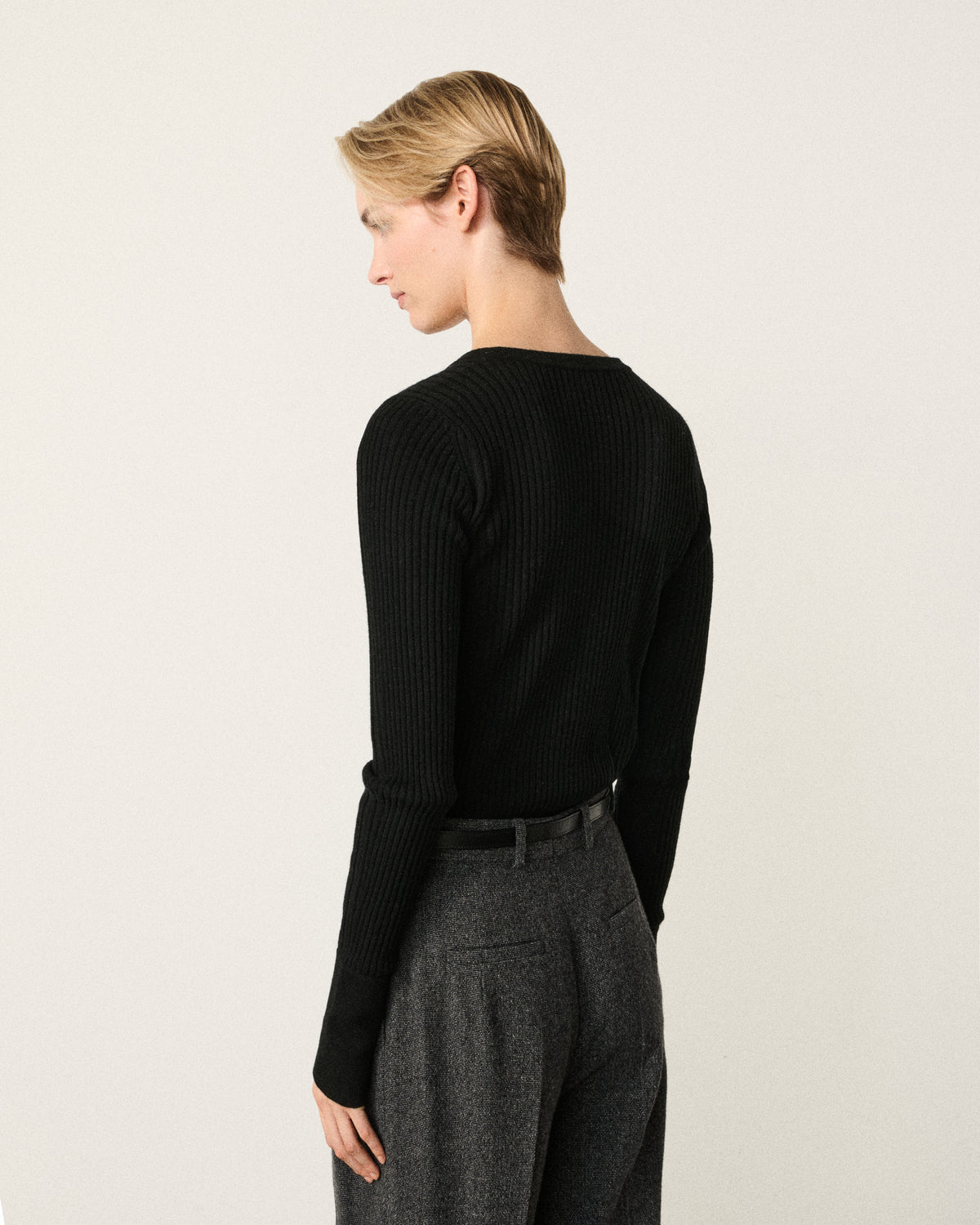 woman in the black henley top, back view