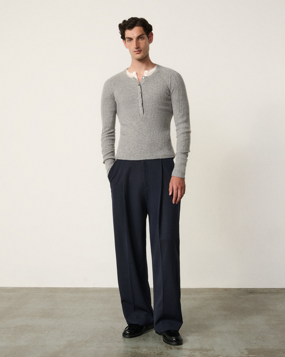 man full body front, light grey ribbed henley with navy trousers