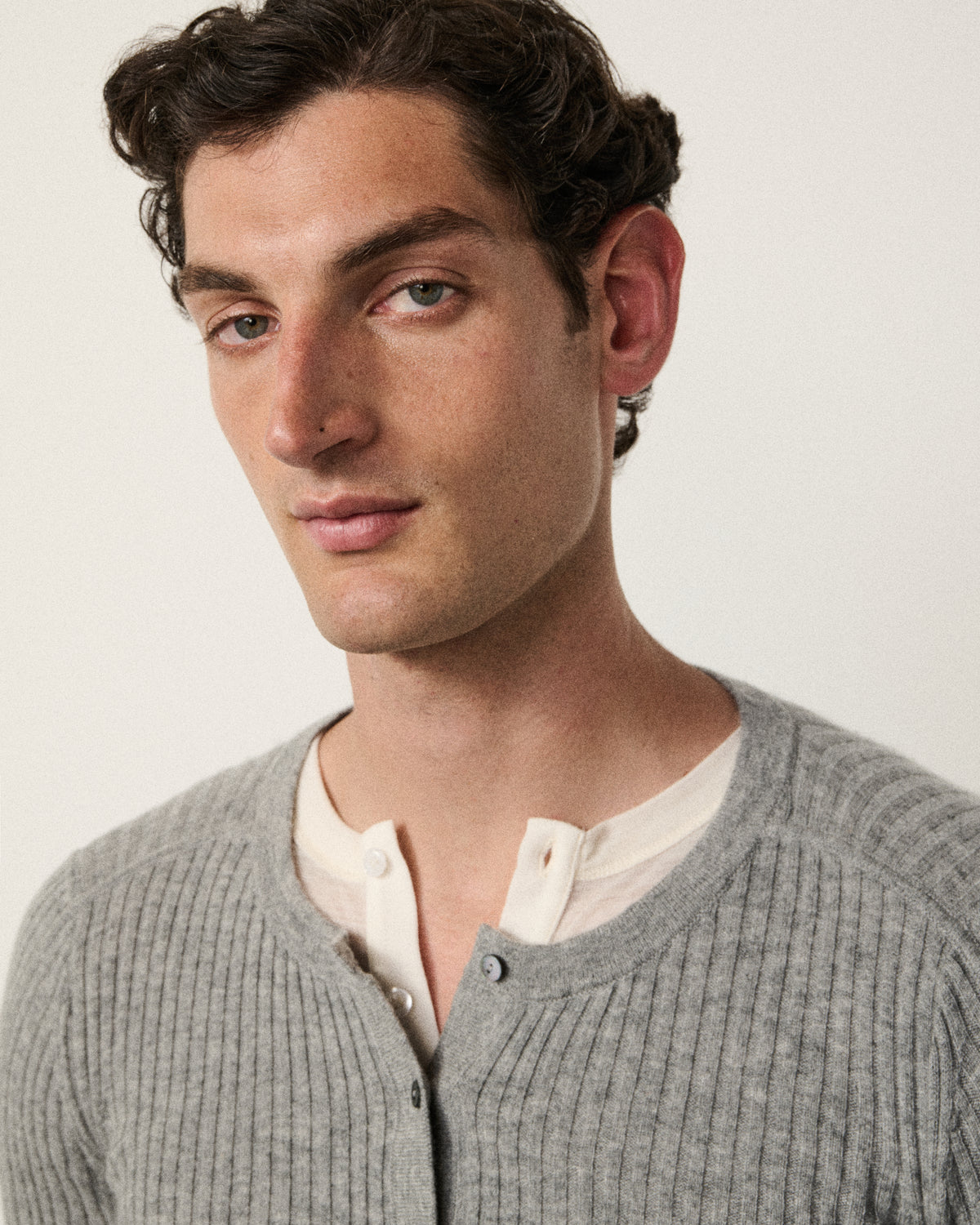 close-up of man's face, light grey ribbed henley