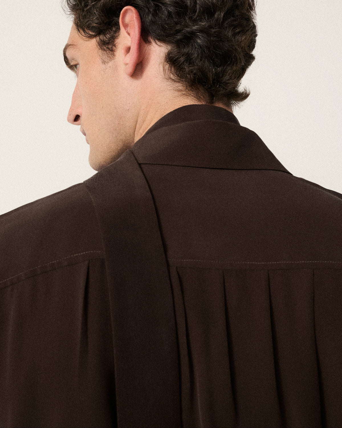 close-up of man's back and neck, silk shirt