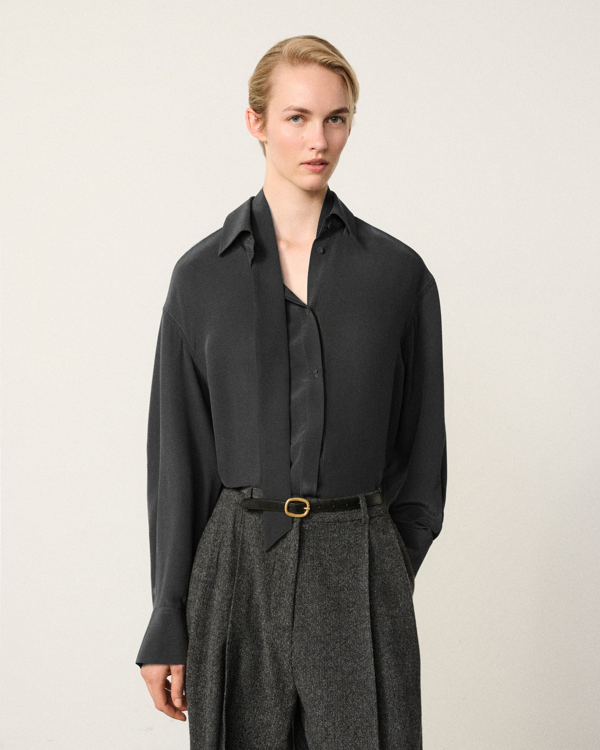 woman in the dark charcoal washed silk shirt with neck tie detail
