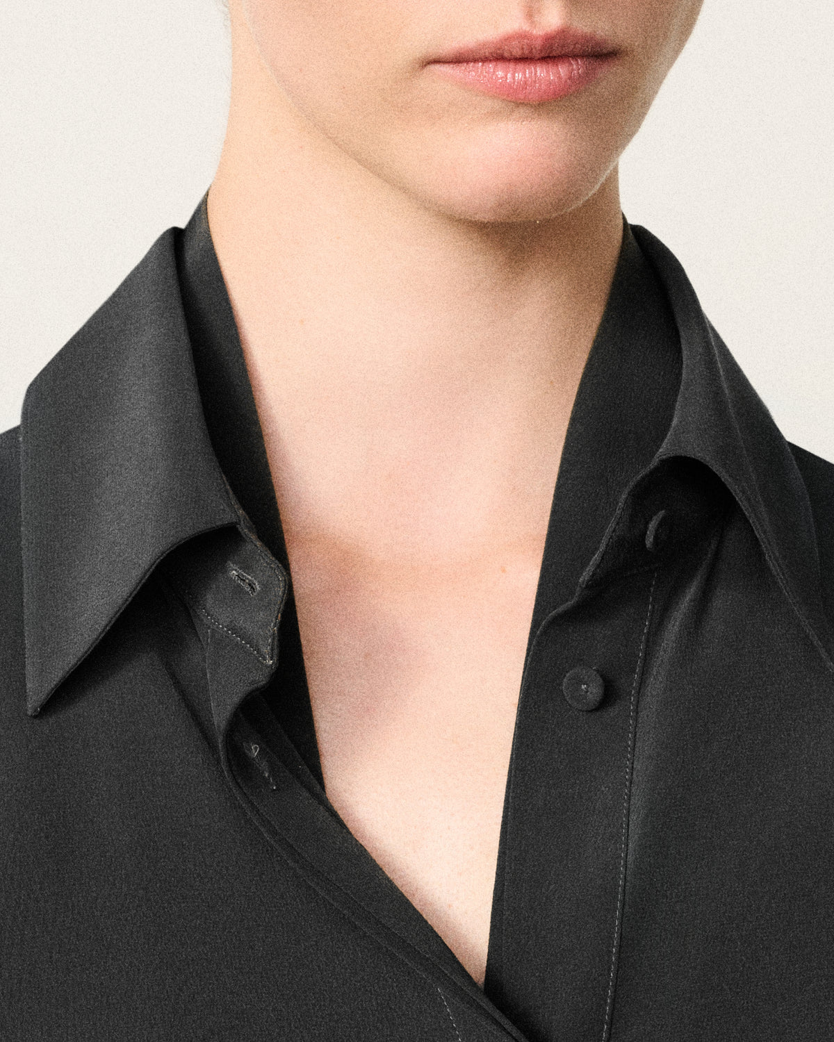 close-up of a woman's neck and the charcoal silk shirt collar