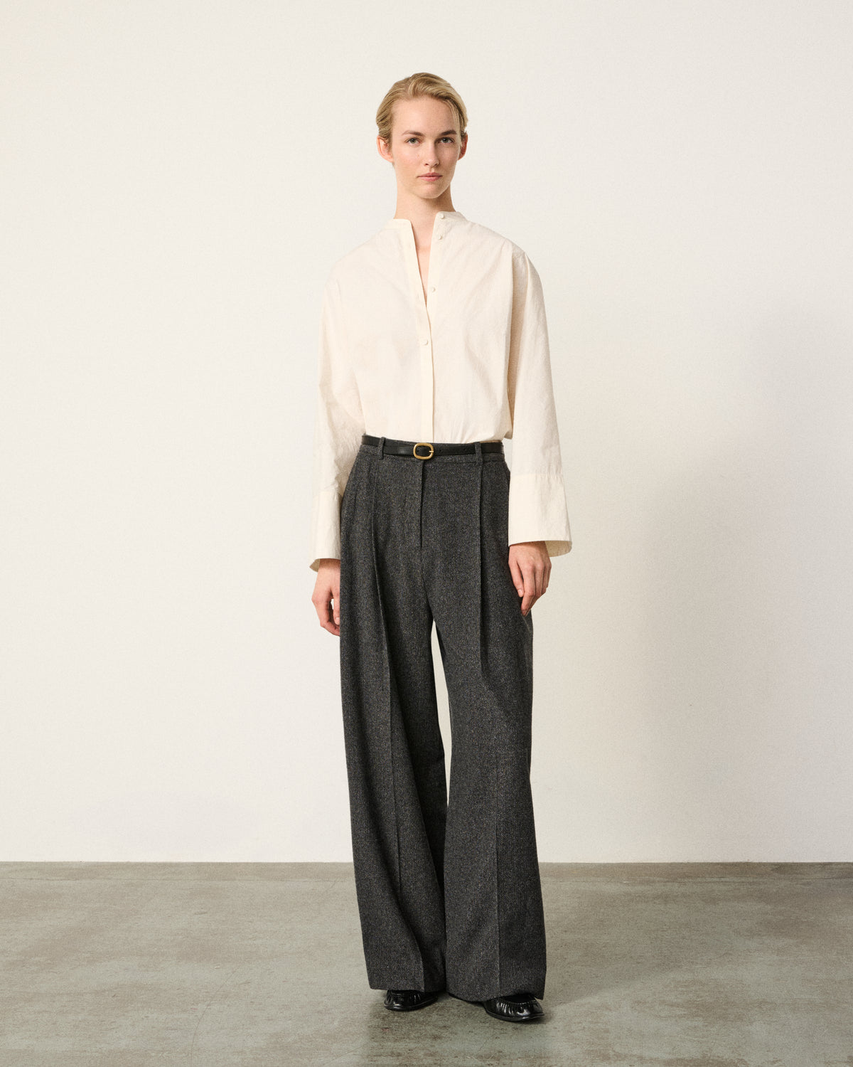 woman front, ecru tunic overshirt with grey trousers