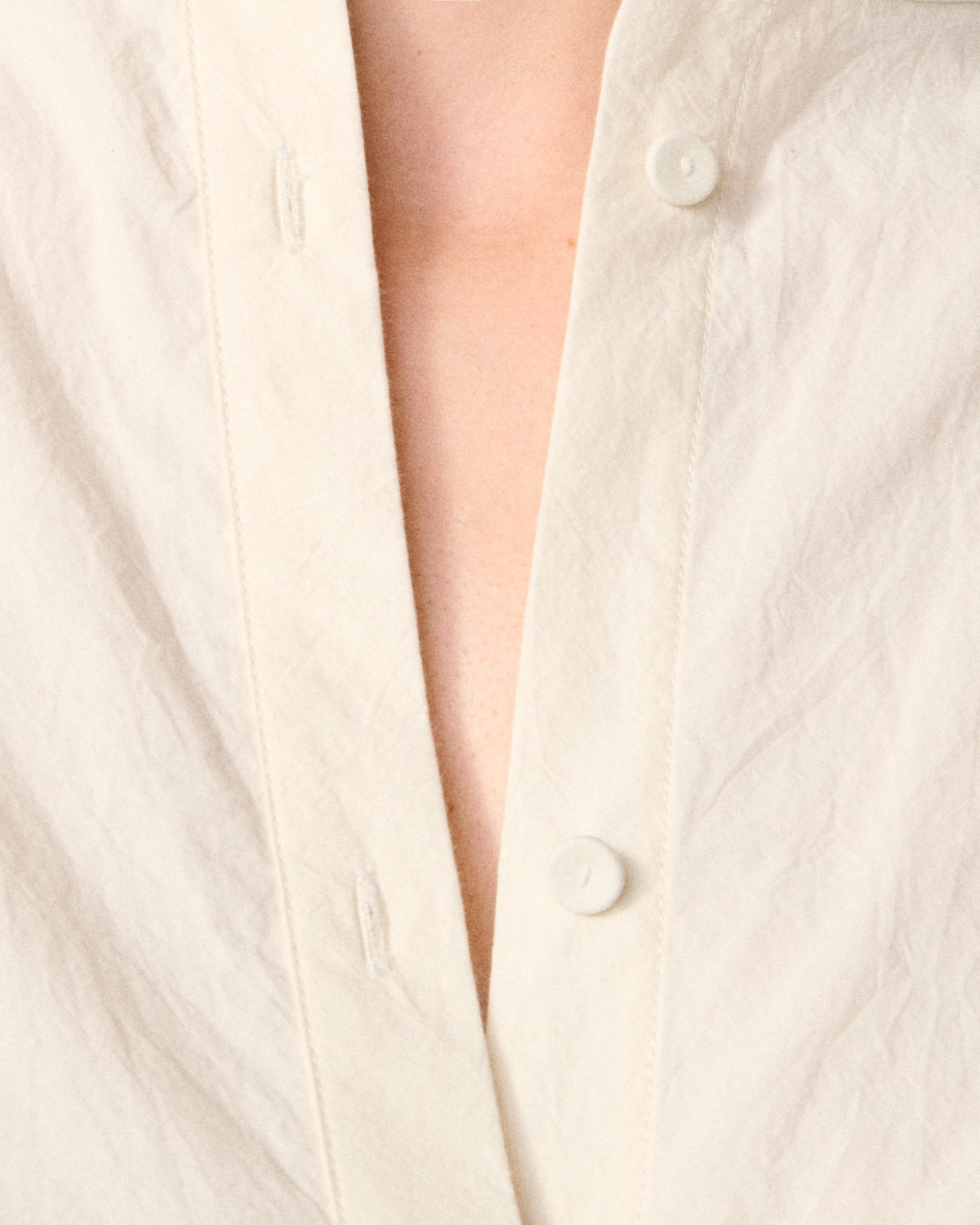 close-up of button and neckline detail