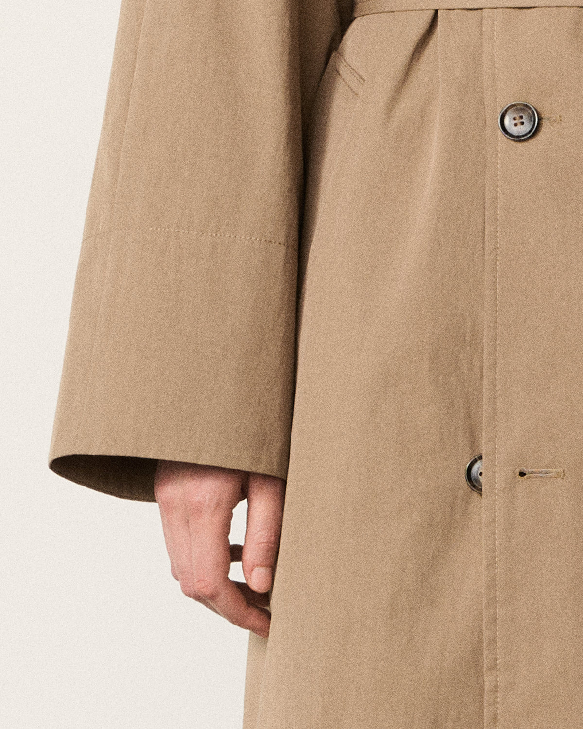 close-up of a hand on the trench coat sleeve