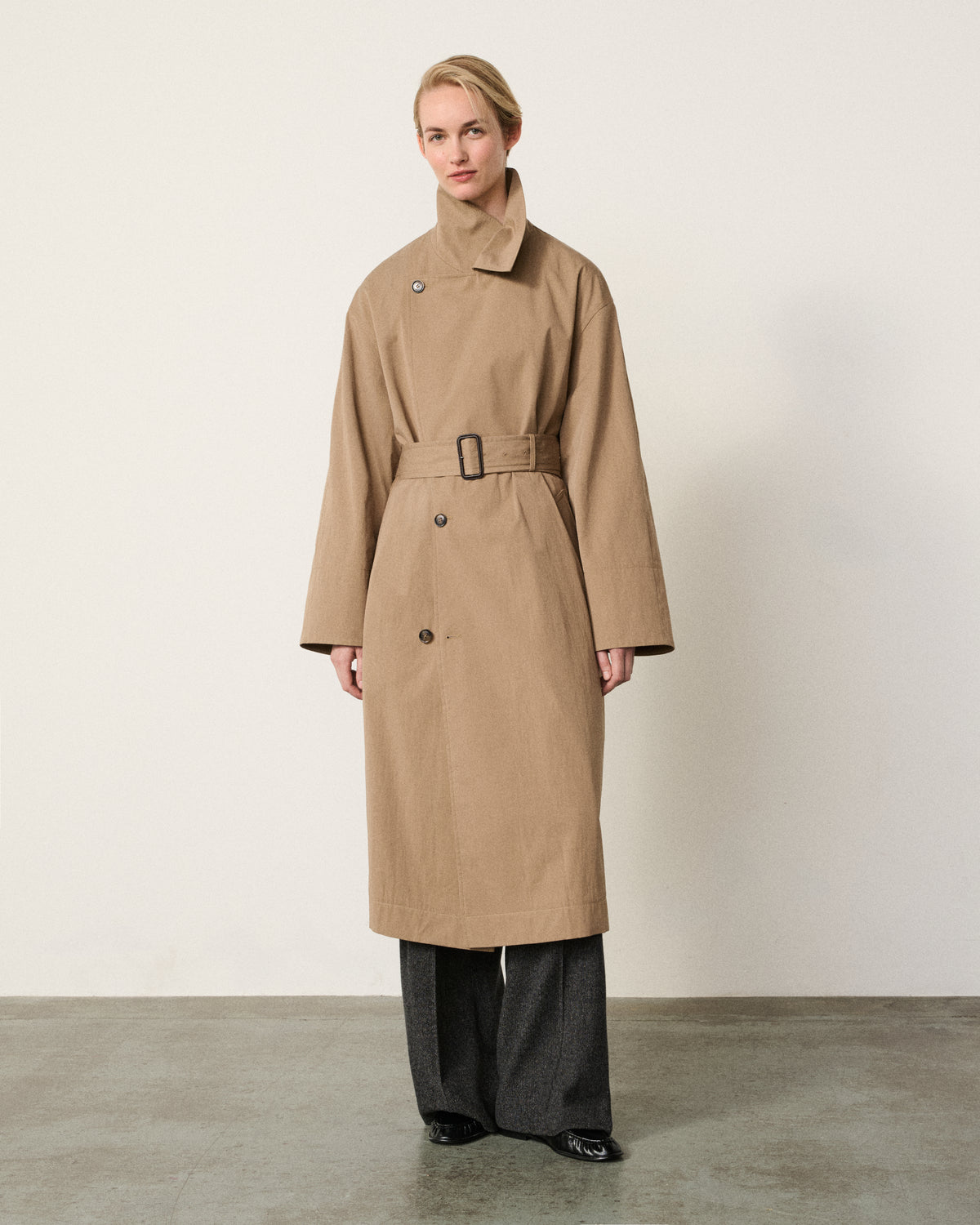 woman in the sand belted trench coat