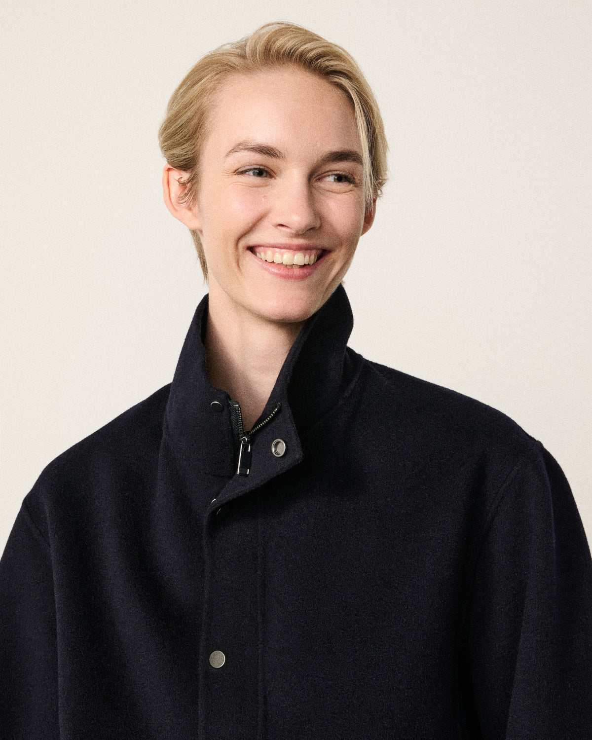 close-up of woman's face, dark navy bomber