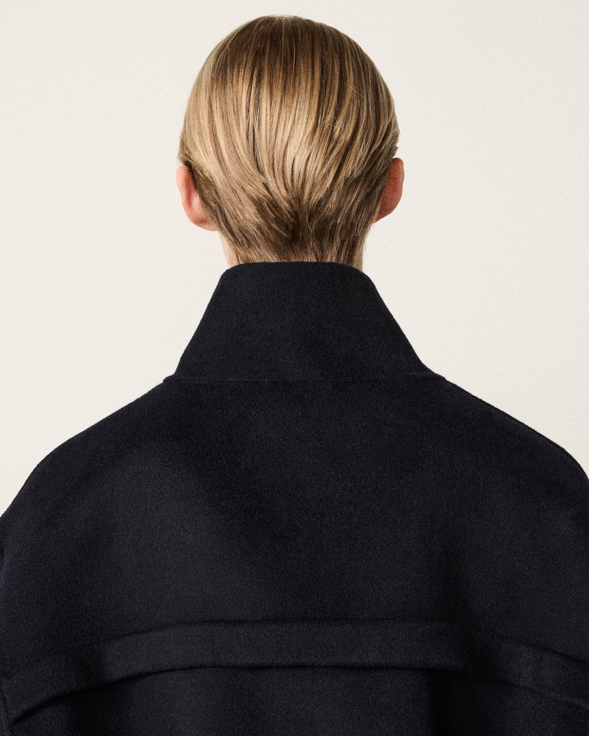 woman back view, dark navy cropped bomber