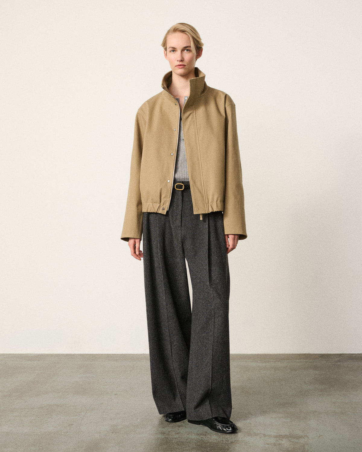 woman in the sand cropped cotton bomber, grey trousers