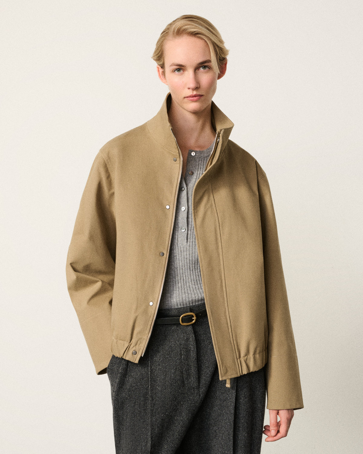 woman in the sand cropped cotton bomber, front view