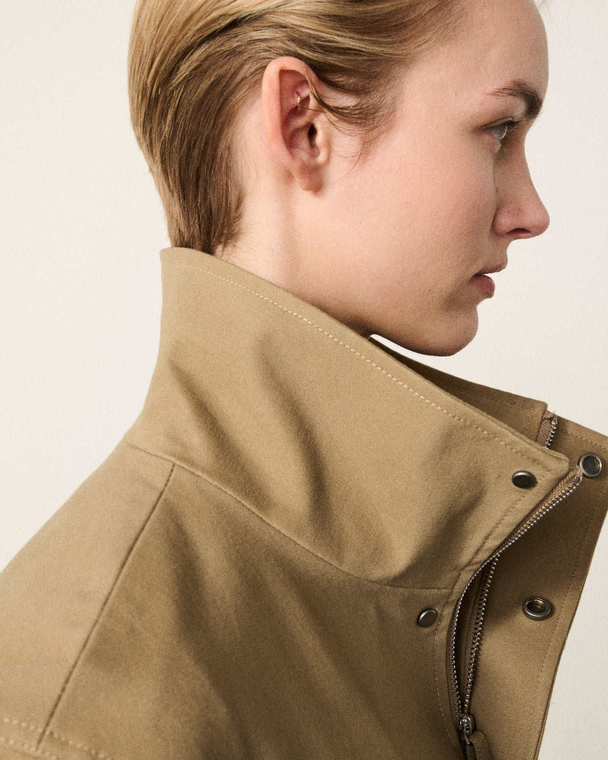 close-up of a woman's face and the sand bomber collar