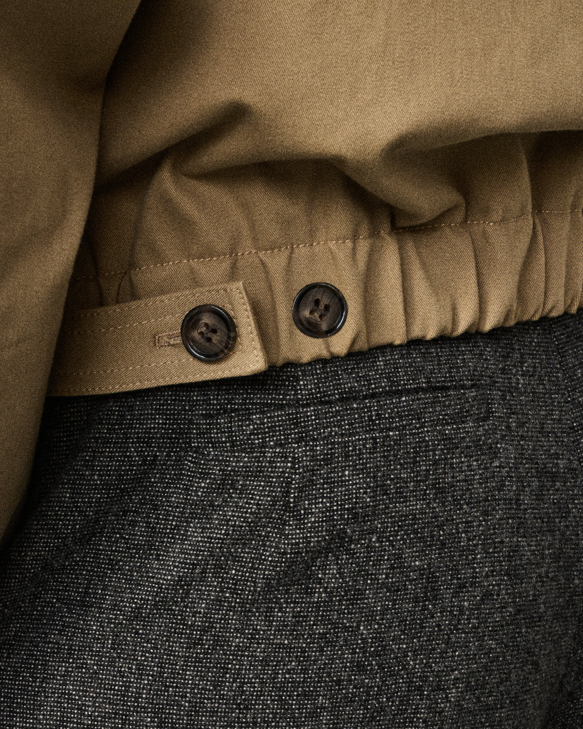 close-up of the sand bomber waistband buttons