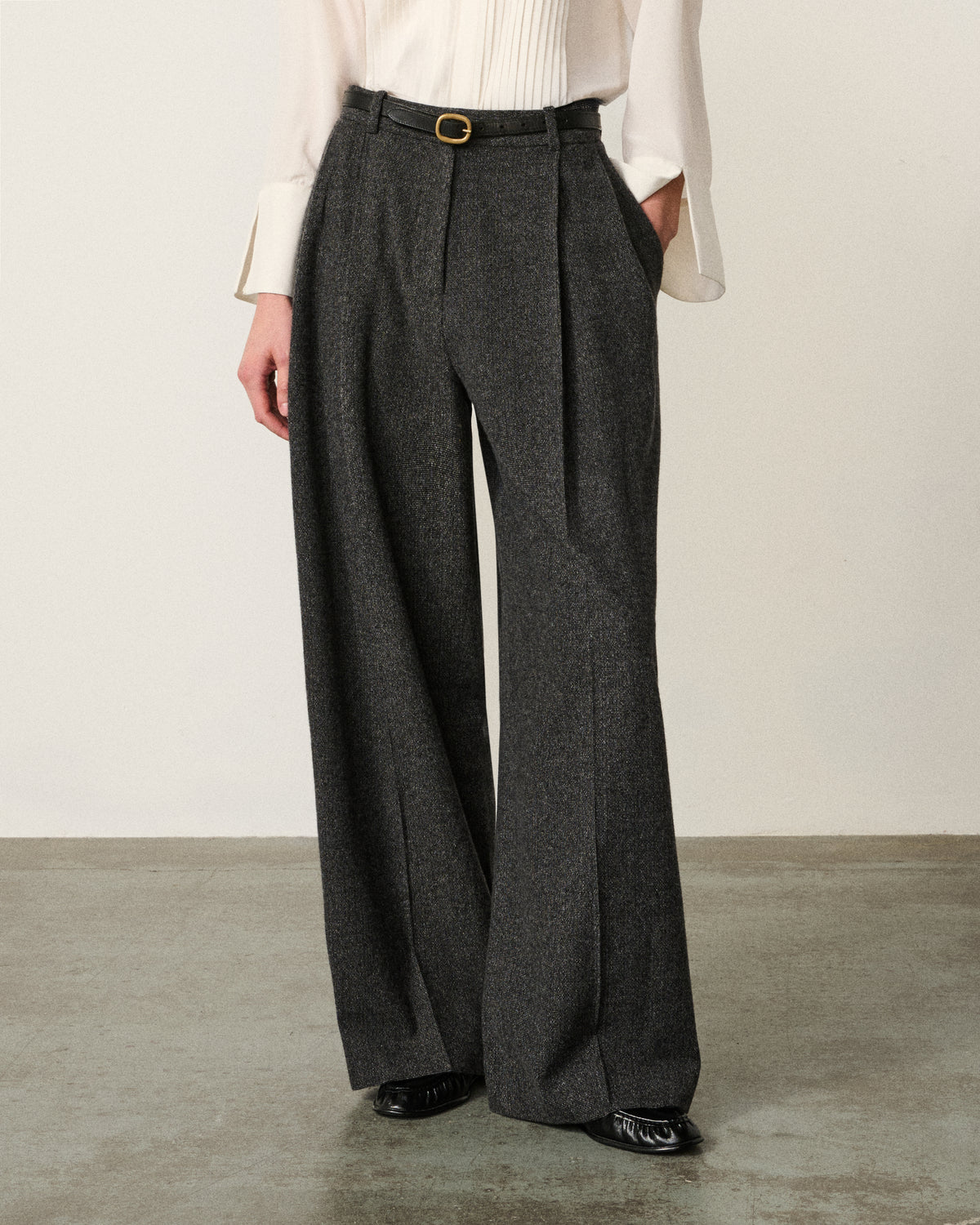 close-up of woman's waist and legs, dark grey wide leg pant