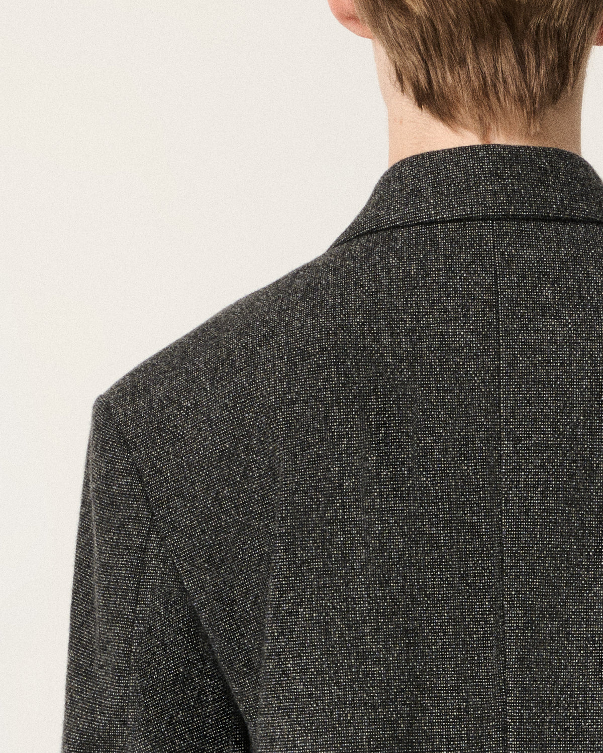 close-up of hair and collar on the dark grey blazer