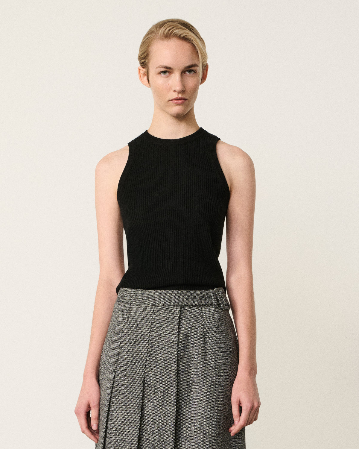 woman in the black ribbed racer vest
