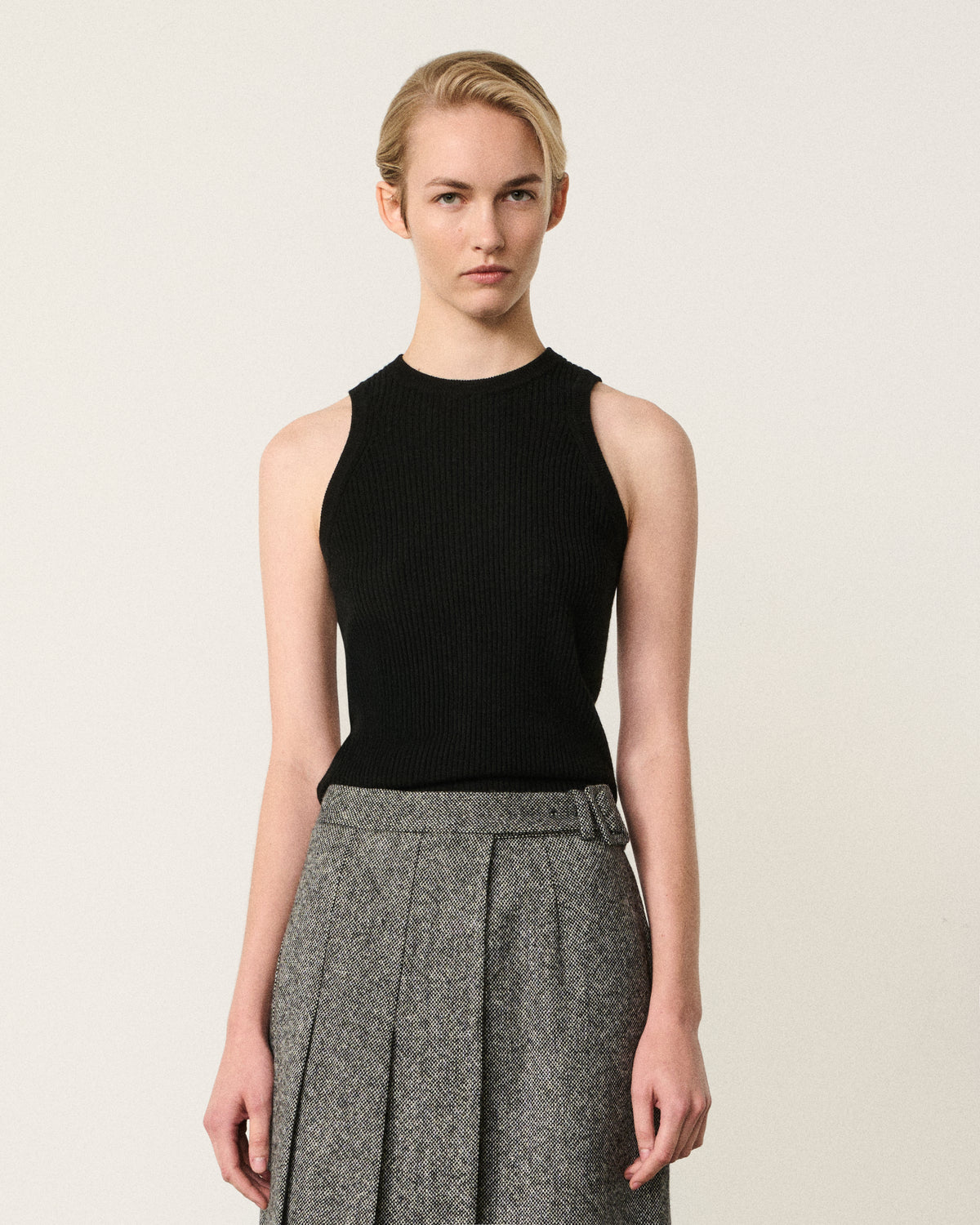 woman in the black and white asymmetric pleated skirt, front view