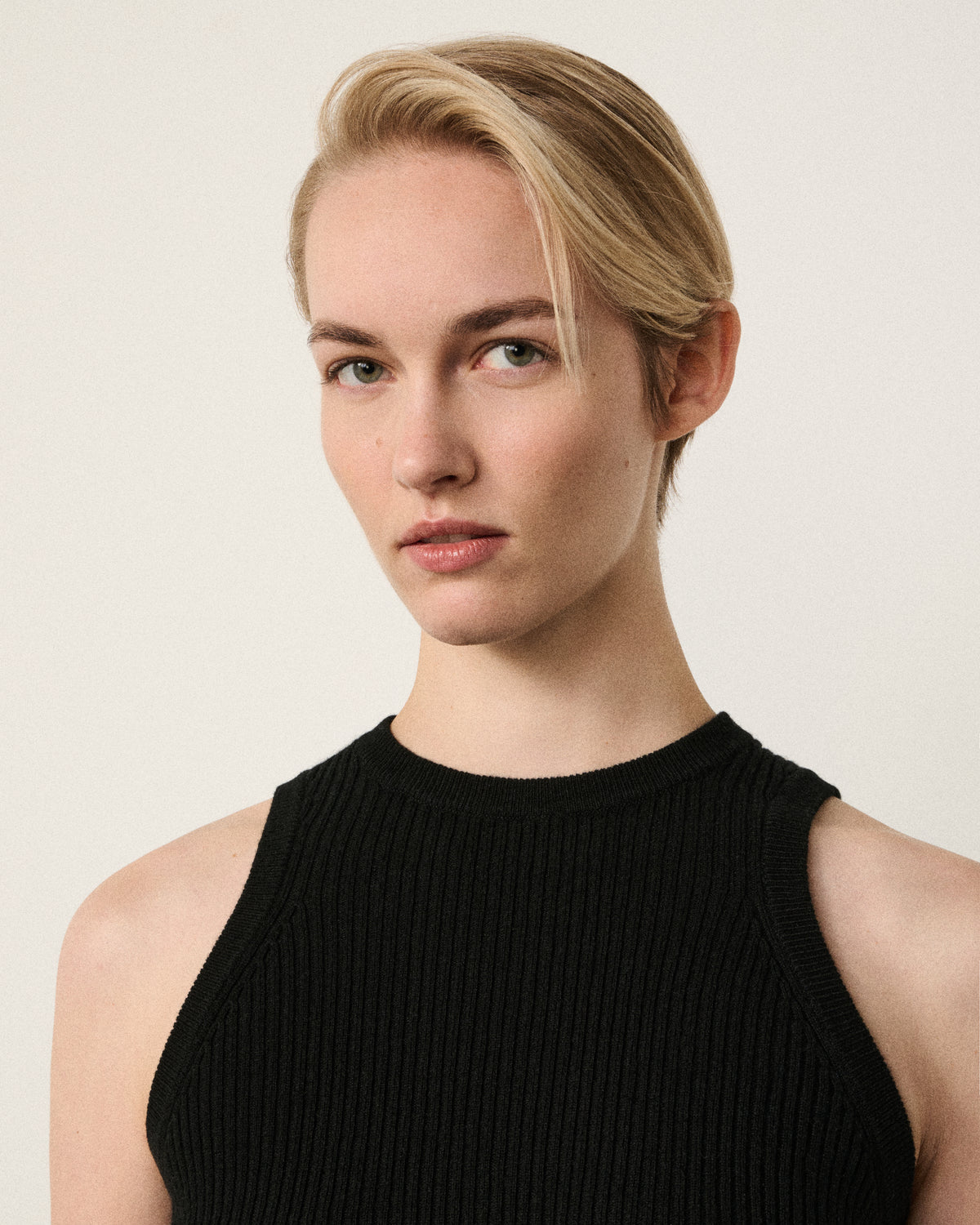 close-up of woman's face, black racer vest