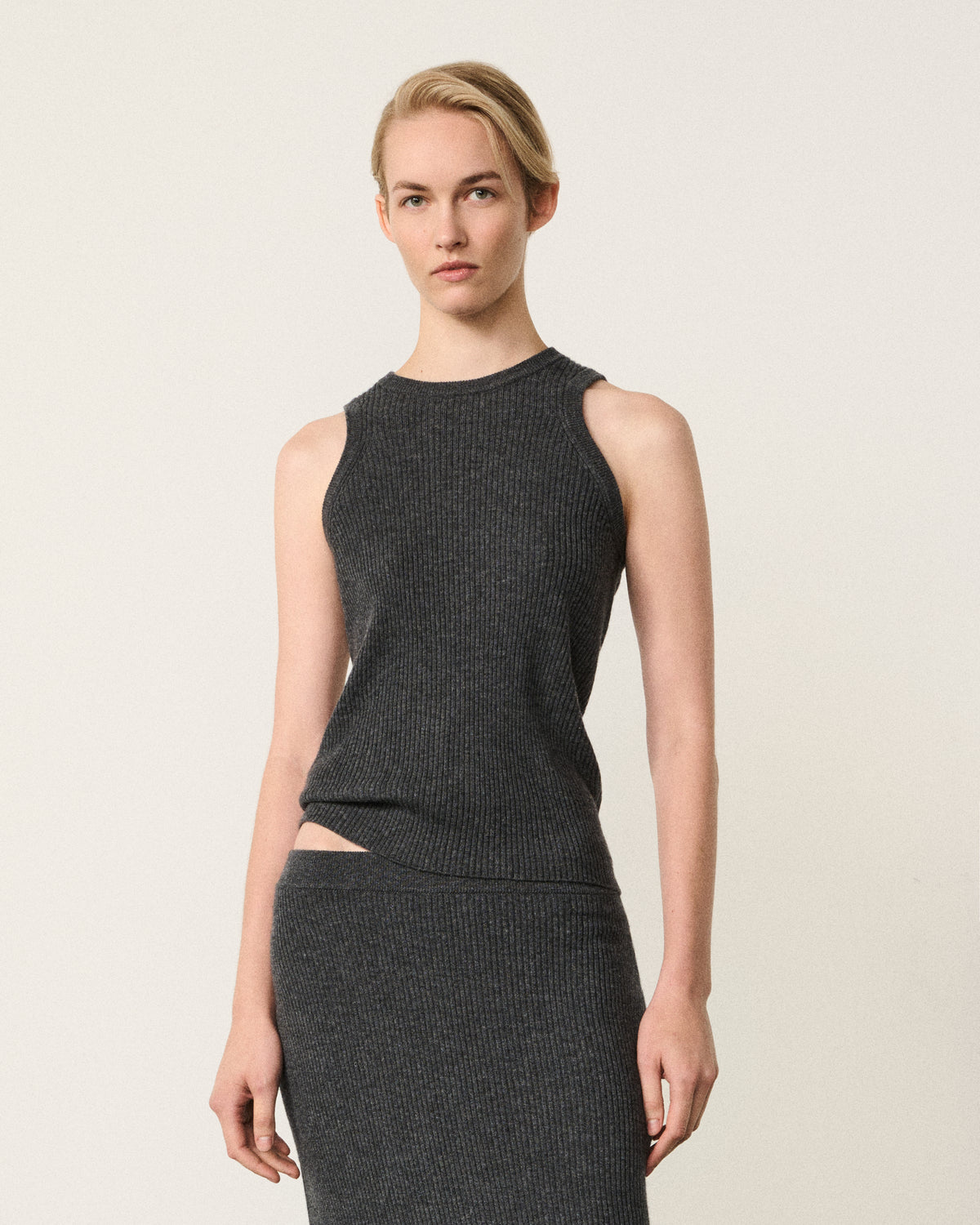 woman wearing the charcoal grey ribbed racer vest
