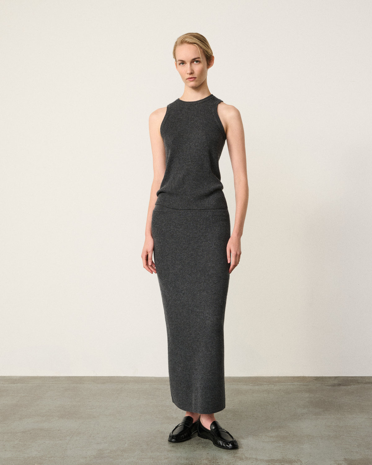 woman wearing the charcoal grey ribbed racer vest