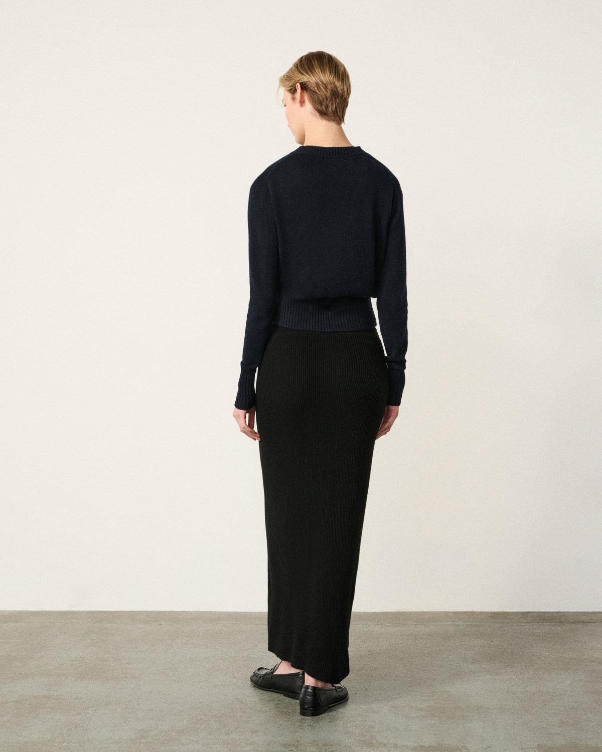 woman back view, black ribbed column midi skirt