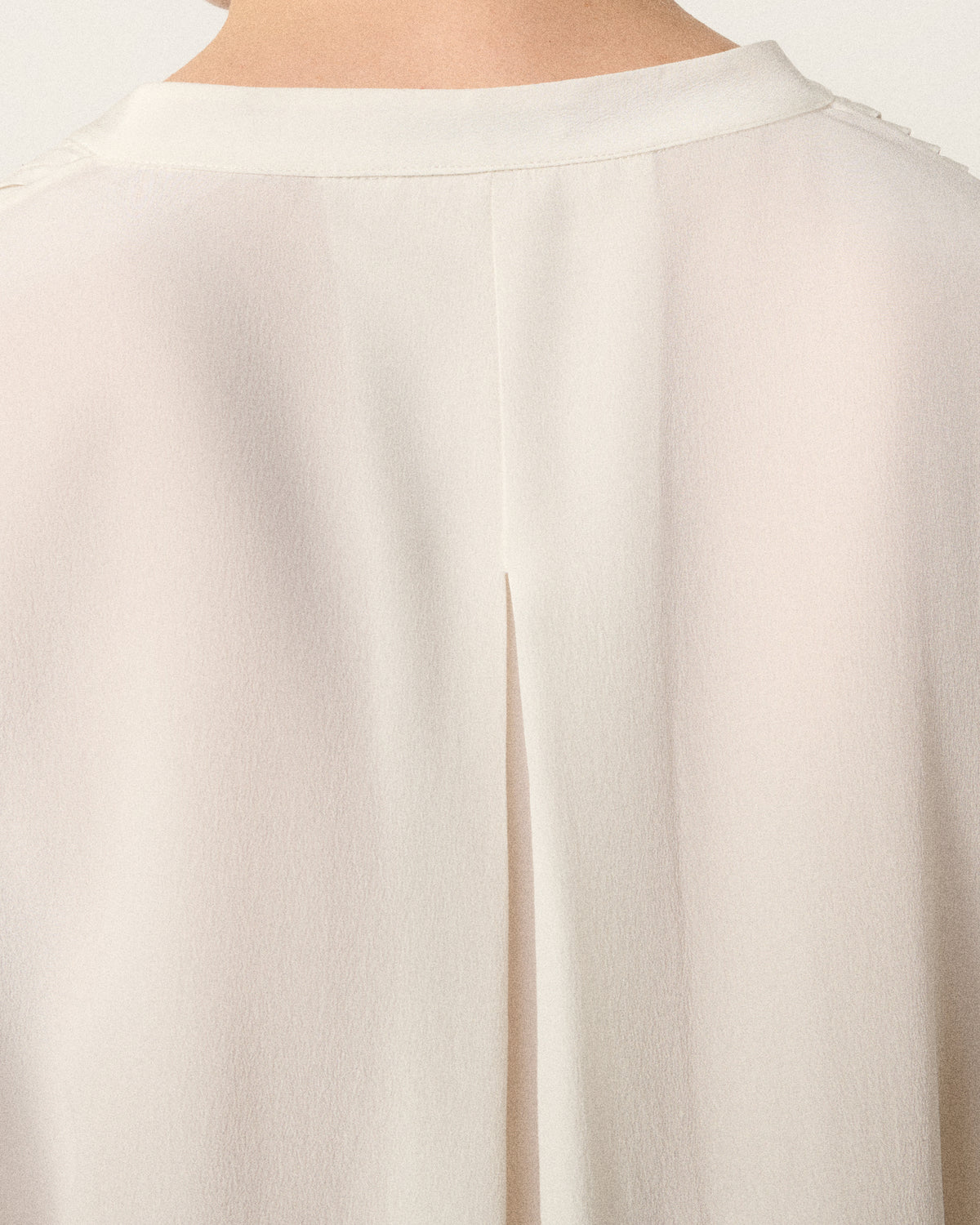 close-up of the ivory tux shirt pleats, back view
