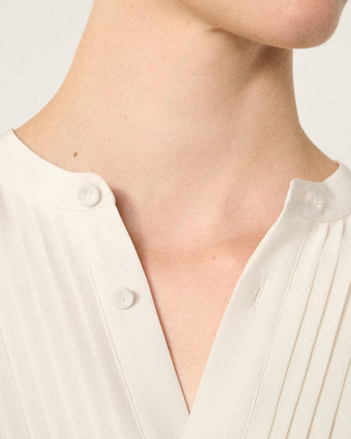 close-up of a woman's neck and the ivory tux shirt collar
