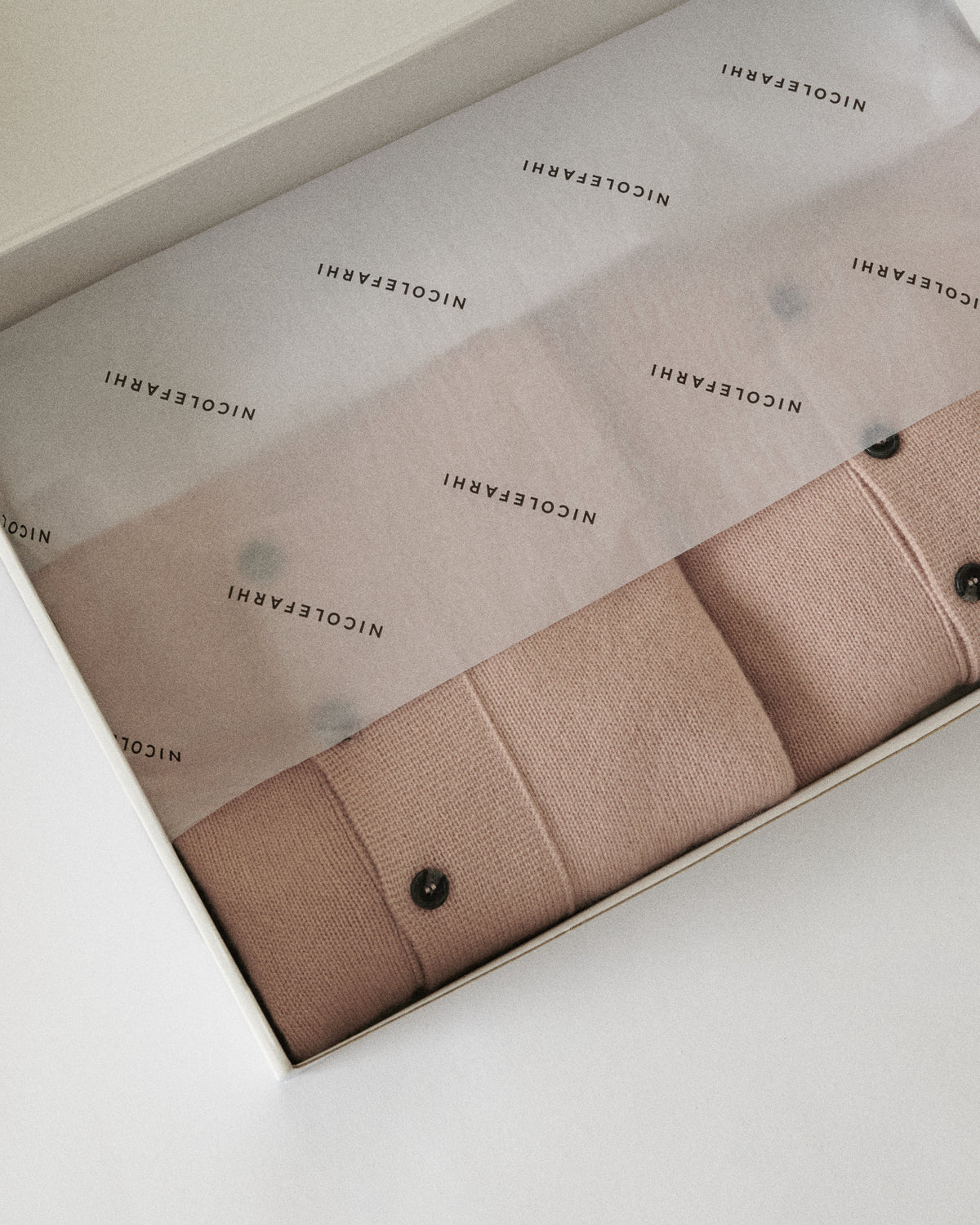 blush pink cardigan folded in a Nicole Farhi gift box